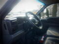 Interior view of a 2007 Ford F-650 showing the steering wheel dashboard and a fire extinguisher on the floor