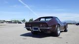 A 1971 Chevrolet Corvette Stingray in a brown color with a sleek design featuring round tail lights and chrome exhaust tips