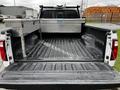 Inside the bed of a 2011 Ford F-250 SD with a black liner and a diamond-plated tool chest on the left side