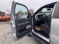 A 2014 Ford F-150 with an open driver's side door revealing the interior dashboard and seats