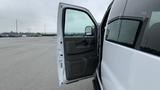 2017 Chevrolet Express Quigley 4x4 with the driver's side door open showing the interior door panel and handle