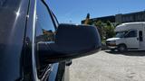 A close-up view of the side mirror of a 2018 Chevrolet Tahoe