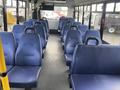 Interior view of a 2018 Chevrolet Express showcasing rows of blue upholstered seats designed for passenger comfort