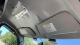 Interior view of a 2013 Ford Econoline showing overhead storage compartments and a speaker grille