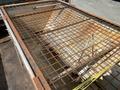 A rusted metal grid covering the flatbed of a 2010 Ford F-550