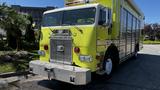 A bright yellow 1995 Freightliner FLL086 fire truck with a silver grille and large front bumper visible in the foreground