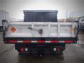 A 2008 Ford F-550 dump truck with a closed bed and visible tail lights and markings on the rear panel