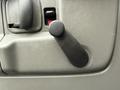 A manual window crank handle on the interior door panel of a 2009 Chevrolet Express