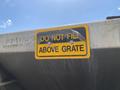 A sign on a vehicle reads DO NOT FILL ABOVE GRATE