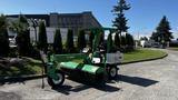 A 2017 Laymor SweepMaster 300 is a green compact street sweeping machine with a large broom and operator's seat visible in the foreground