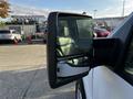 Side mirror of a 2008 Ford F-150 XL showing a reflection of the surroundings and a glimpse of the vehicle's interior