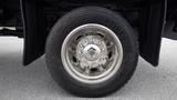 A close-up view of a chrome wheel from a 2008 Ford F-450 SD featuring a polished rim and a Continental tire