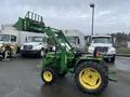 A 2003 John Deere 790 tractor with a front loader attachment and large rear tires