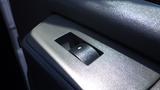 Close-up of the door handle on a 2015 GMC Savana with a textured gray surface and a visible mechanism for opening the door