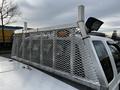 A 2014 Ford F-250 SD equipped with a silver metal mesh safety cage and a mounted light on the rear section of the truck