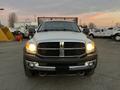 A 2008 Dodge Ram 5500 with a silver and black exterior is facing forward with its headlights on and a grille that features the Dodge logo