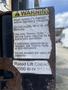 A worn warning label attached to a 2008 Dodge Ram 5500 providing safety instructions and lift capacity information