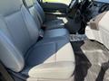 A 2016 Ford F-350 SD has gray leather front seats with armrests and seat belts visible inside the vehicle