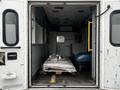 Interior of a 2016 Chevrolet Express ambulance showing empty space with a wooden pallet and cargo inside