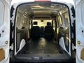 Interior view of a 2022 Ford Transit Connect cargo van showing spacious empty cargo area with two front seats visible