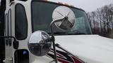 A 2009 Hino 338 garbage truck with large side mirrors showing raindrops on their surfaces and a distinctive white and red paint design on the front