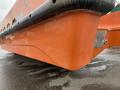 Close-up view of a bright orange 2008 Fassmer 20 Foot Fast Rescue boat showing its distinctive hull shape and design features