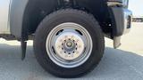 Close-up of a silver 2011 Ford F-450 SD wheel featuring a large black tire and a metallic wheel rim with multiple bolts