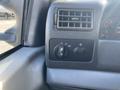 Dashboard controls of a 2003 Ford F-450 SD including knobs for lights and other features