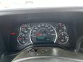 Dashboard of a 2015 Chevrolet Express showing speedometer fuel gauge and warning lights with a digital odometer displaying 192774 km and temperature of 13 degrees Celsius