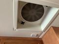 Ceiling vent fan of a 2008 Newmar Canyon Star 36 Foot Class A Motorhome with a circular grille and a control knob on the side