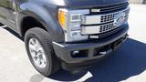 A 2017 Ford F-350 SD with a chrome grille and silver wheels is shown from a close angle highlighting the front bumper and tire