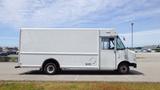 A white 2011 Ford Econoline cargo van with a boxy shape and large cargo area parked on a lot