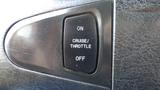 A close-up of a vehicle control panel button labeled ON CRUISE THROTTLE OFF