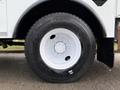A large black tire mounted on a white rim of a 2007 International 4200 truck with visible tread pattern and lug nuts
