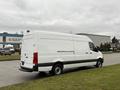 A white 2019 Mercedes-Benz Sprinter van parked on a paved area with grass nearby