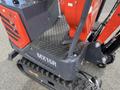 A 2024 AGT Mini Excavator with a red and black design featuring a textured metal platform and a tracked undercarriage