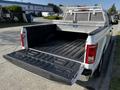A 2017 Ford F-150 with an open truck bed featuring a rubber mat and a metal ladder rack installed on the cab