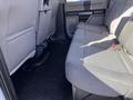 Rear seating area of a 2019 Ford F-350 SD with gray fabric upholstery and rubber floor mats