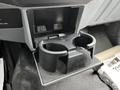 A black cup holder insert with two compartments designed for beverages inside a vehicle's console