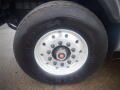 A close-up of a wheel from a 2008 International 7400 featuring a silver rim with multiple lug nuts and a black tire marked with the Goodyear brand name