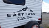 2021 Forest River 312BH East To West Della Terra travel trailer featuring a design with mountains and the text East West Della Terra on the side