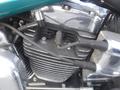 Close-up of a black motorcycle engine with chrome accents and spark plug wires on a 2009 Harley-Davidson Flstc