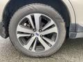 Close-up of a wheel and tire from a 2019 Subaru Outback featuring a five-spoke alloy rim and a rugged tire tread design