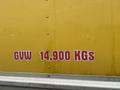 A yellow truck with the text GVW 14,900 KGS displayed prominently on its side