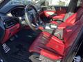 Interior of a 2023 Acura MDX featuring red leather seats a modern dashboard and a leather-wrapped steering wheel