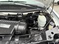 Engine compartment of a 2009 Chevrolet Express showing the engine components and fluid reservoirs