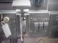 Close-up of the gearshift and control panel of a 2003 Freightliner MT45 Chassis showing the gear selector and several switches