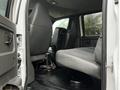 Interior view of a 2005 GMC C5 Duramax showing front and back seats with gray upholstery and seatbelts attached