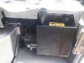 A black motor unit with a ventilation pipe and a warning label is situated inside a silver compartment of a 2007 Morgan Olson Workhorse W42 vehicle
