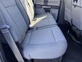 Interior view of a 2019 Ford F-350 SD showing the rear seating area with gray upholstery and seat belts